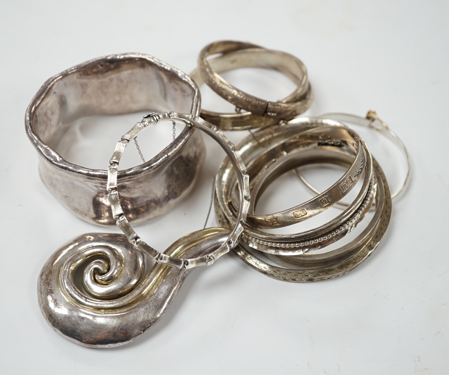 A small group of assorted silver and white metal jewellery, including bangles, brooches, etc. Condition - poor to fair